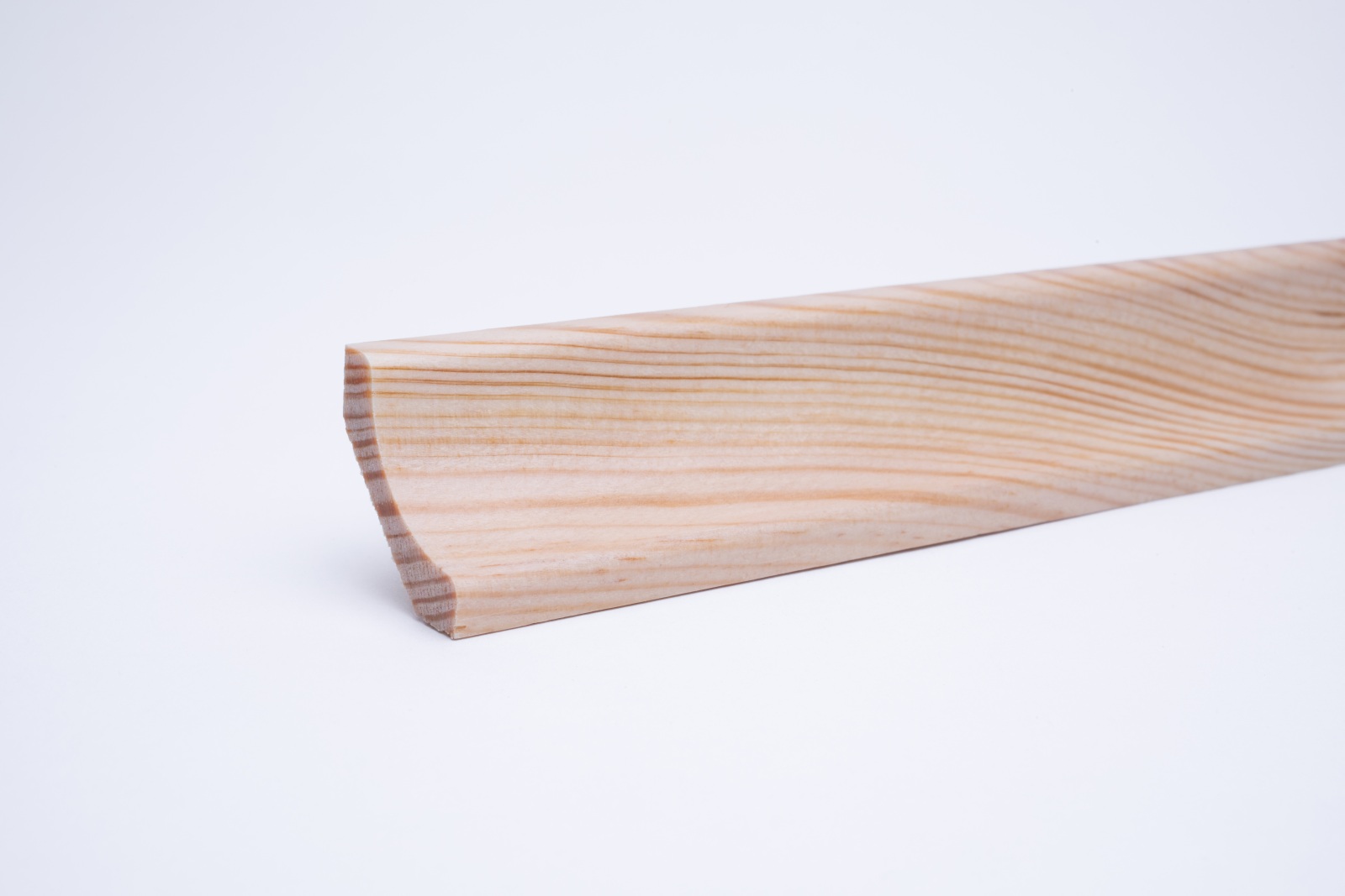 Real wood skirting as coved profile in pine varnished
